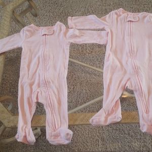 Two pink and white striped footed pajamas